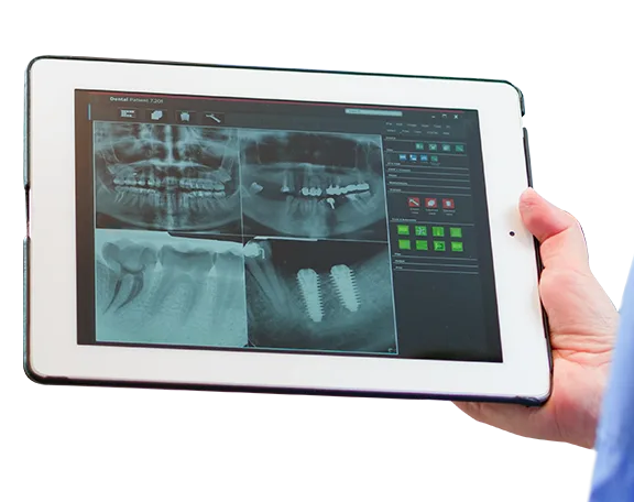 Dentist in Los Algodones checking a patient's x-rays